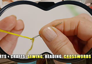 Extreme close-up of a woman pulling thread through her sewing needle
